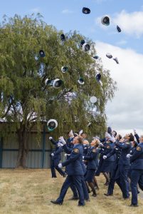 Graduating Constables throw hats in the air